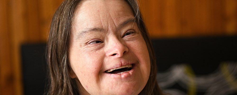 Smiling woman with brown hair.